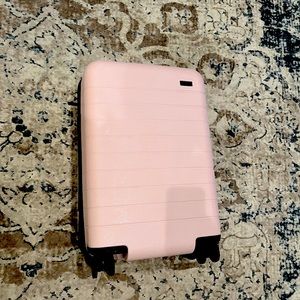 AWAY Millennial Pink Carry-On Suitcase with battery pack.